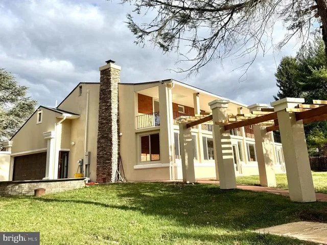 a view of a living room kitchen with stainless steel appliances kitchen island granite countertop a large window and a counter top space