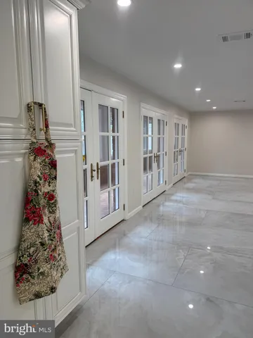 a spacious bedroom with a bed and a view of cupboard