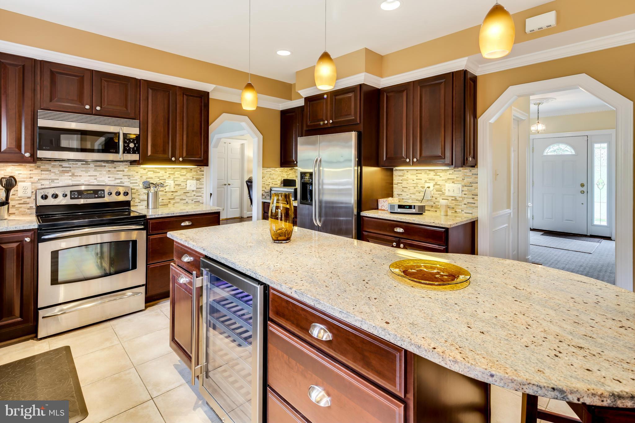 14608 Cutstone Way Silver Spring, MD 20905 - Photo 7 of 30 a kitchen with granite countertop stainless steel appliances and wooden cabinets