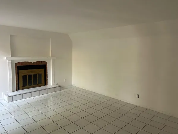 a view of an empty room with a fireplace