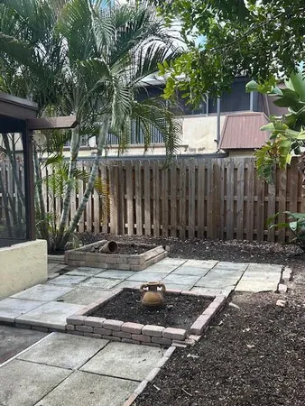 a backyard of a house with table and chairs