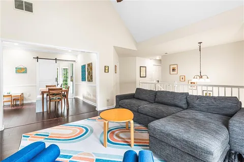 a living room with furniture and a dining table