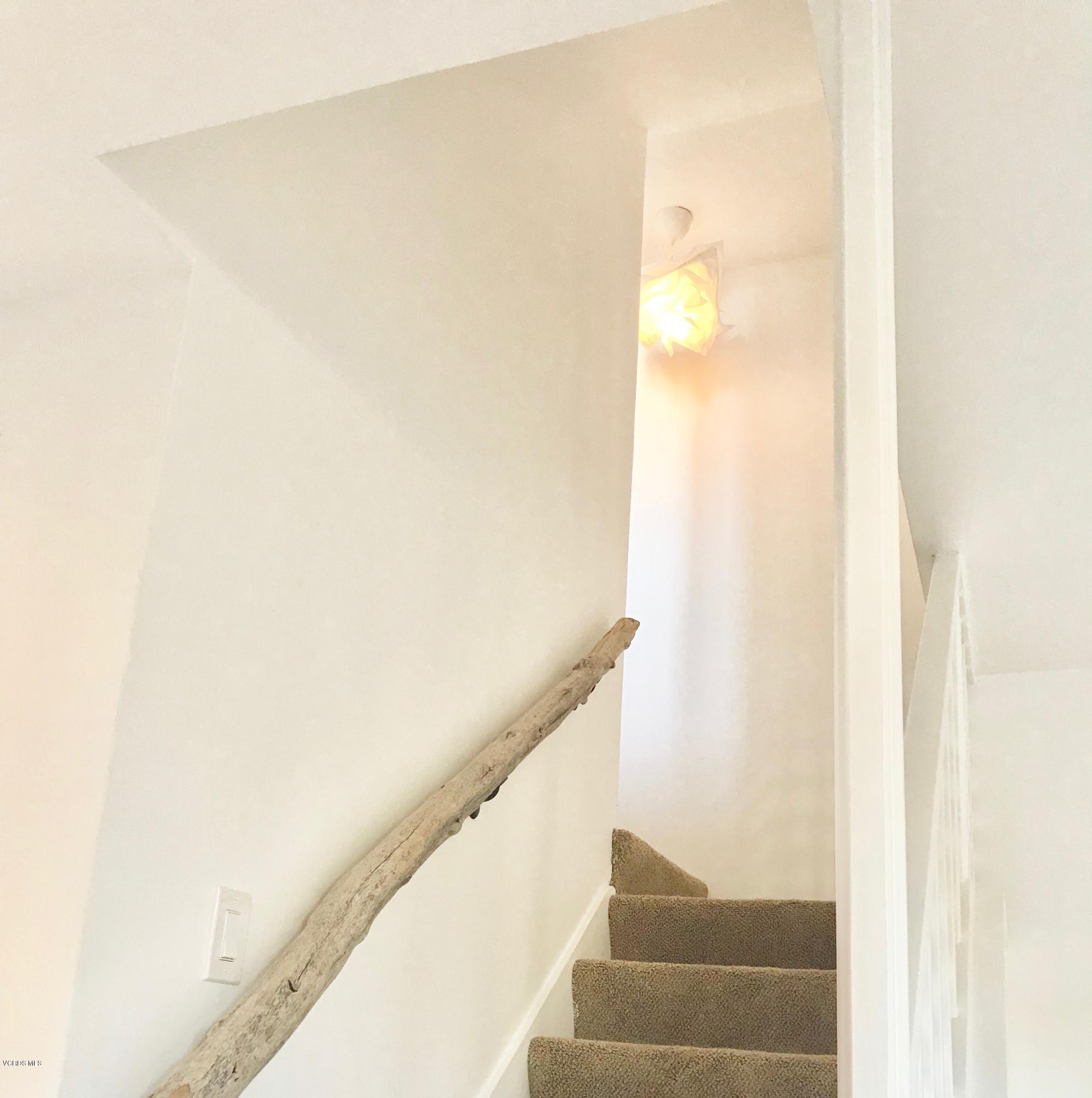 5205 West Wooley Road, Unit 1 Oxnard, CA 93035 - Photo 12 of 21 a view of staircase with white walls and white door