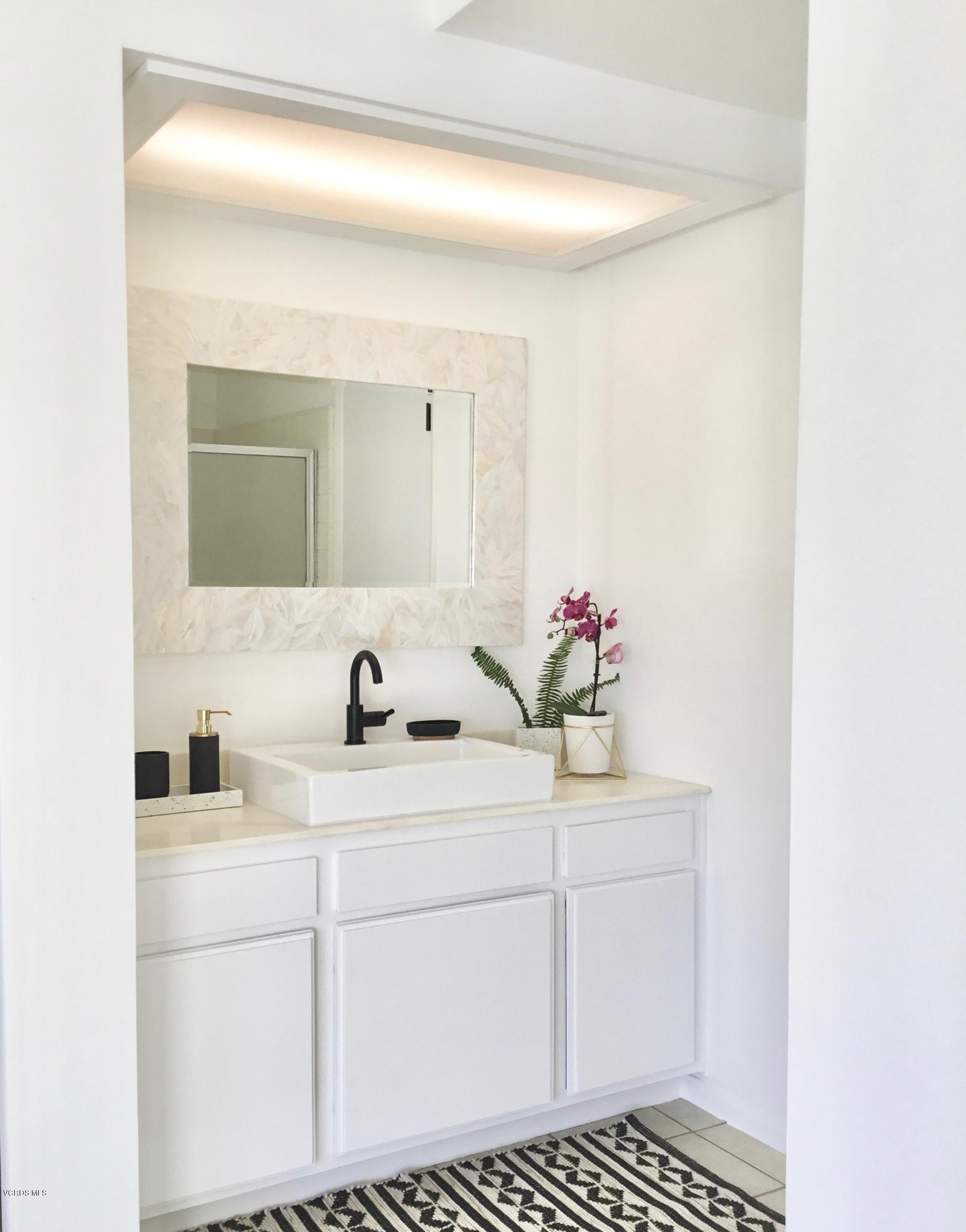 5205 West Wooley Road, Unit 1 Oxnard, CA 93035 - Photo 14 of 21 a bathroom with a sink and a mirror