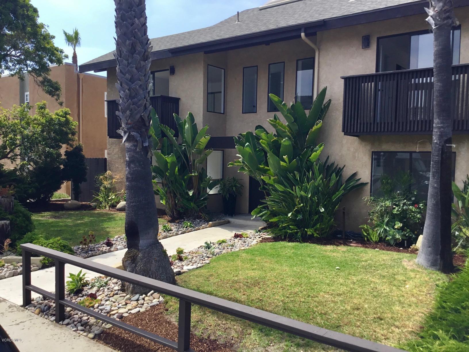 5205 West Wooley Road, Unit 1 Oxnard, CA 93035 - Photo 21 of 21 a view of a house with wooden fence next to a yard