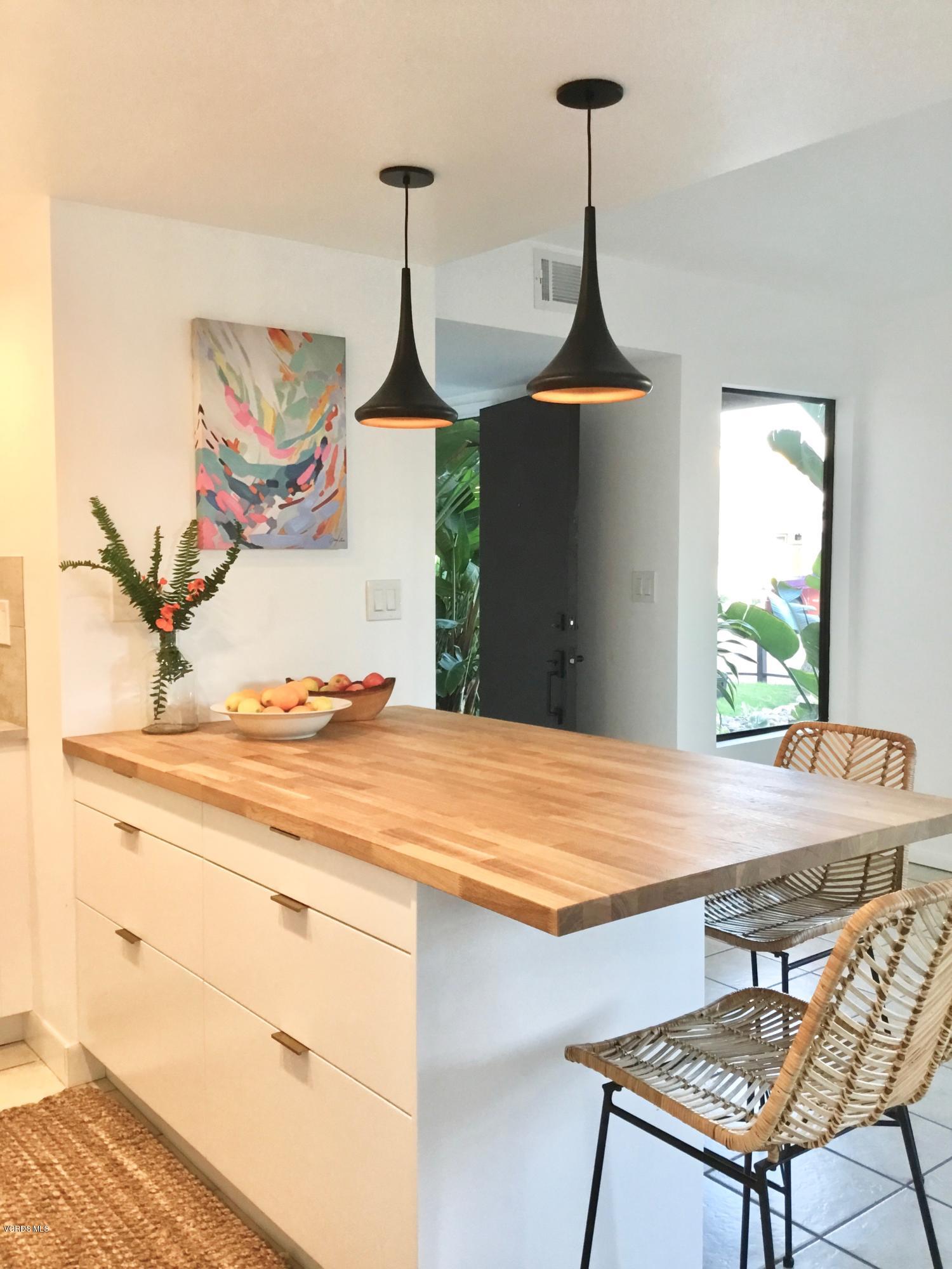 5205 West Wooley Road, Unit 1 Oxnard, CA 93035 - Photo 7 of 21 a dining room with a table and chairs