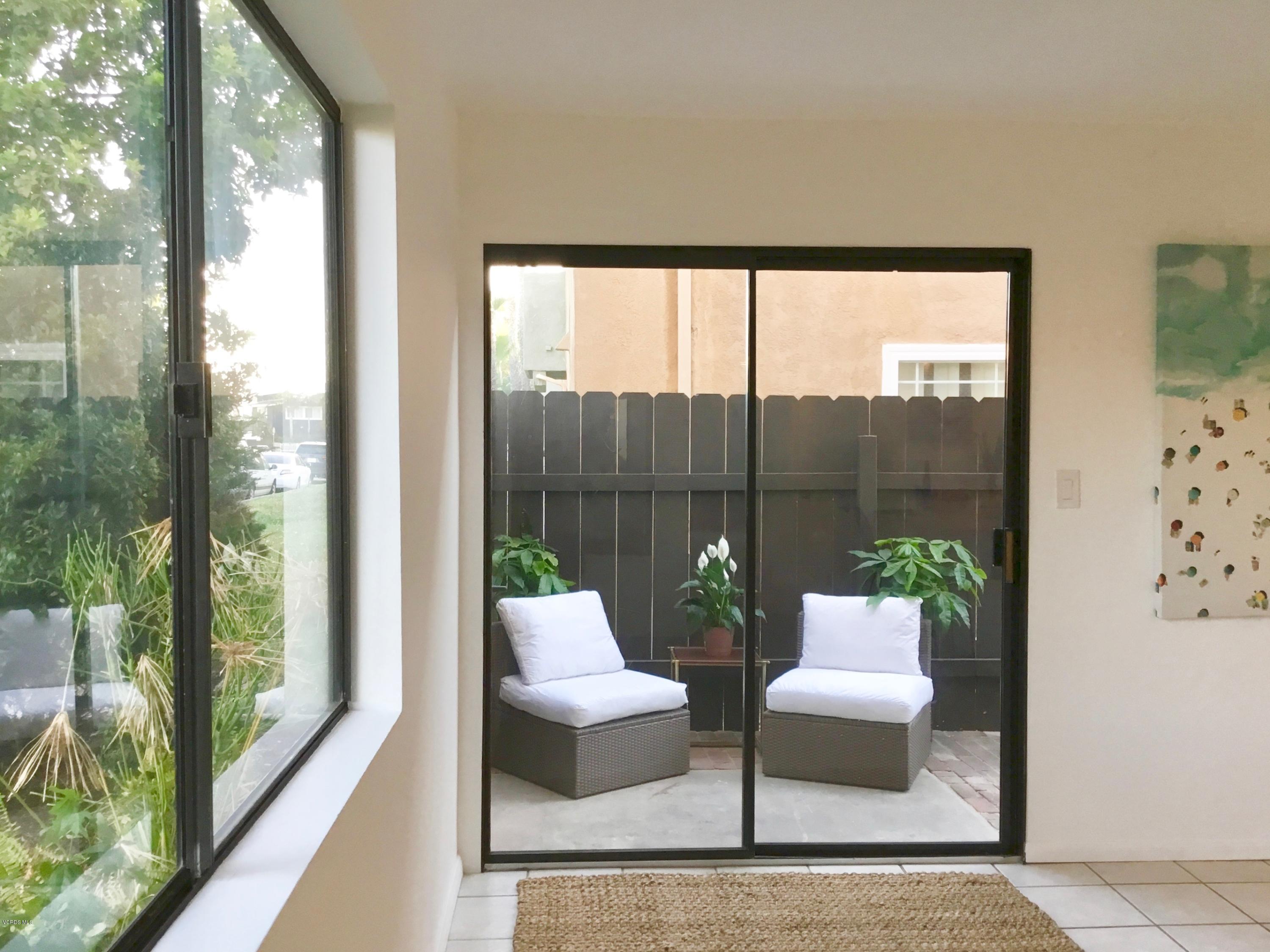 5205 West Wooley Road, Unit 1 Oxnard, CA 93035 - Photo 8 of 21 a living room with furniture and a floor to ceiling window