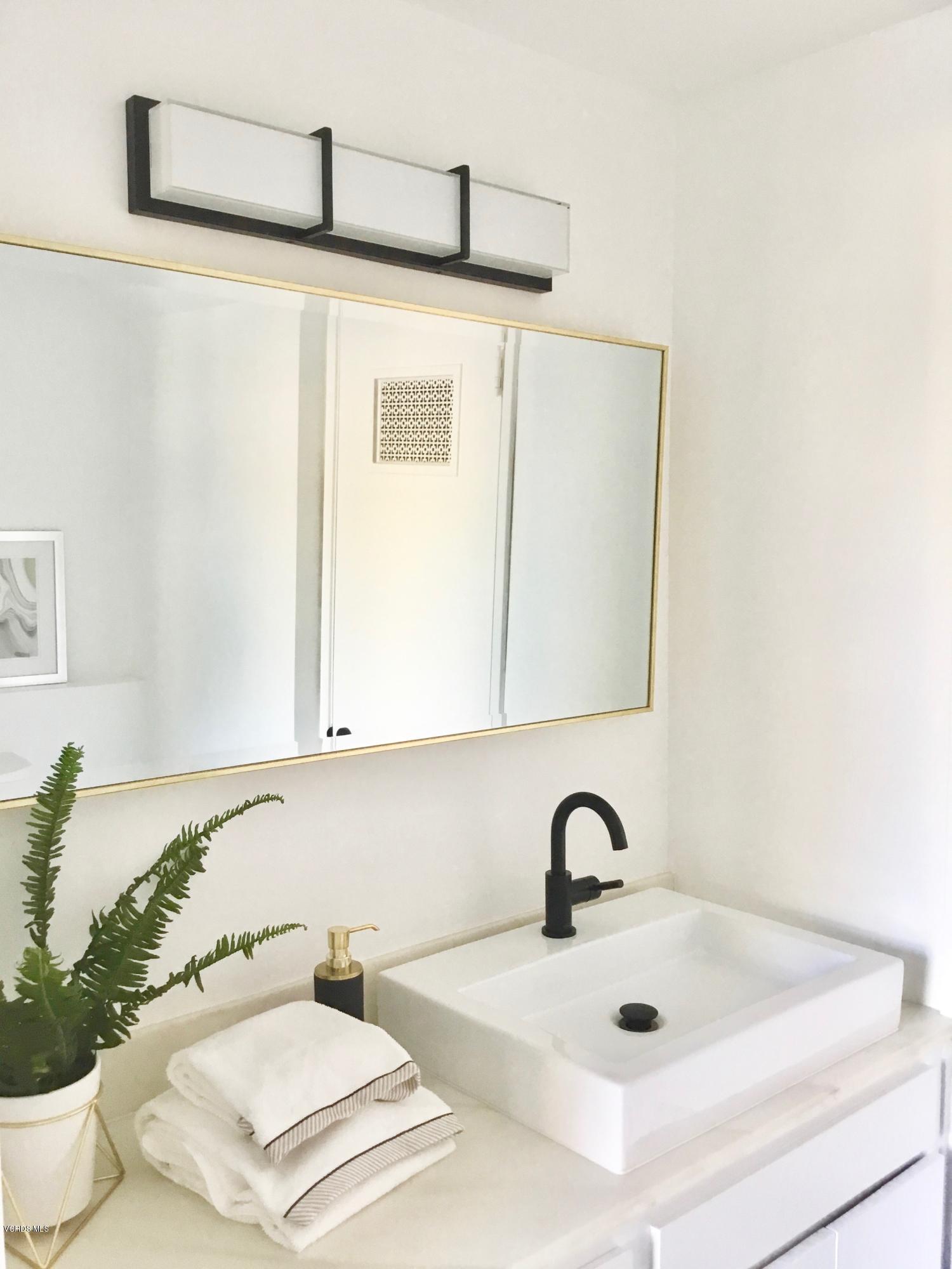 5205 West Wooley Road, Unit 1 Oxnard, CA 93035 - Photo 10 of 21 a bathroom with a sink and a mirror