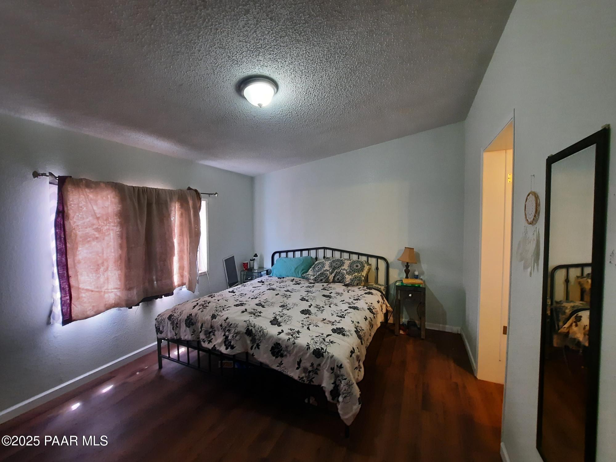 61333 Rough Rock Road Seligman, AZ 86337 - Photo 11 of 34 a bedroom with a bed and window