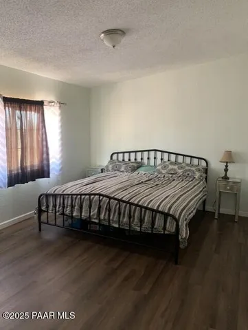 a bed sitting in a bedroom next to a window