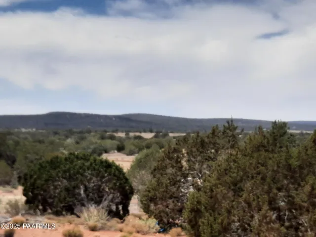 a view of a large mountain with mountains in the background