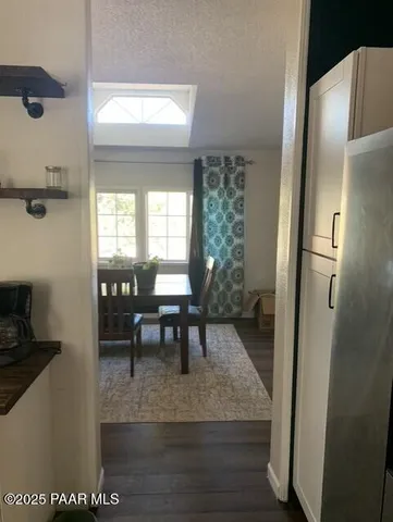 a view of a dining room with furniture and a window