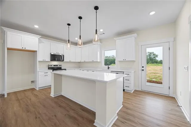 a kitchen with white cabinets and white appliances
