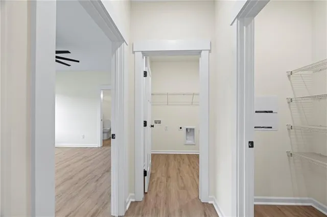 a view of a hallway with wooden floor