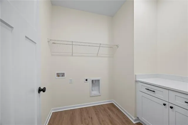 a view of a room with wooden floor