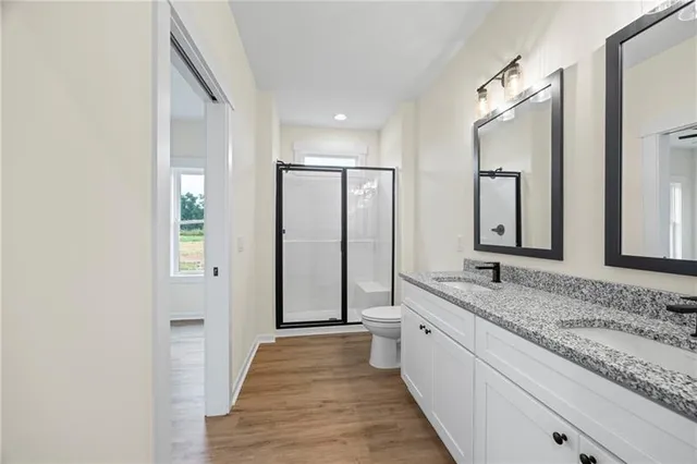 a spacious bathroom with a granite countertop sink and a mirror