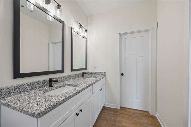 633 Racetrack Road Toccoa, GA 30577 - Photo 27 of 37 a bathroom with a granite countertop sink and a mirror