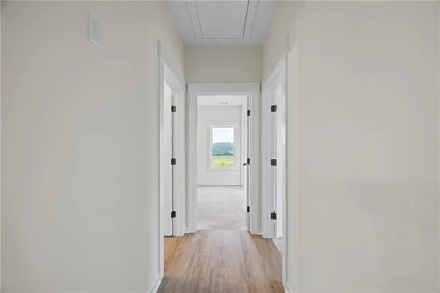 a view of a hallway with wooden floor