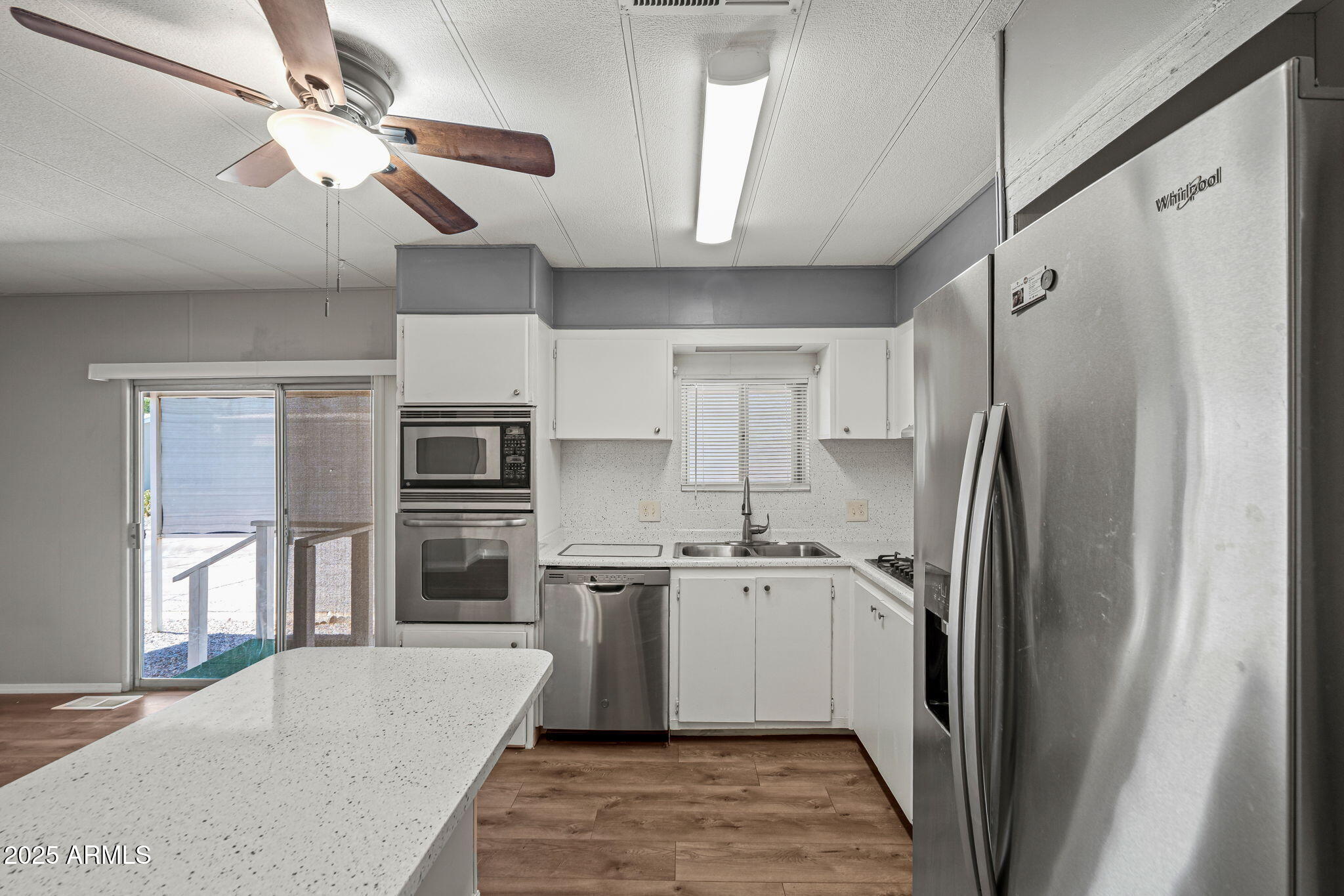 201 South Greenfield Road, Unit 207 Mesa, AZ 85206 - Photo 1 of 50 a kitchen with stainless steel appliances granite countertop a refrigerator a oven a sink with island and chairs