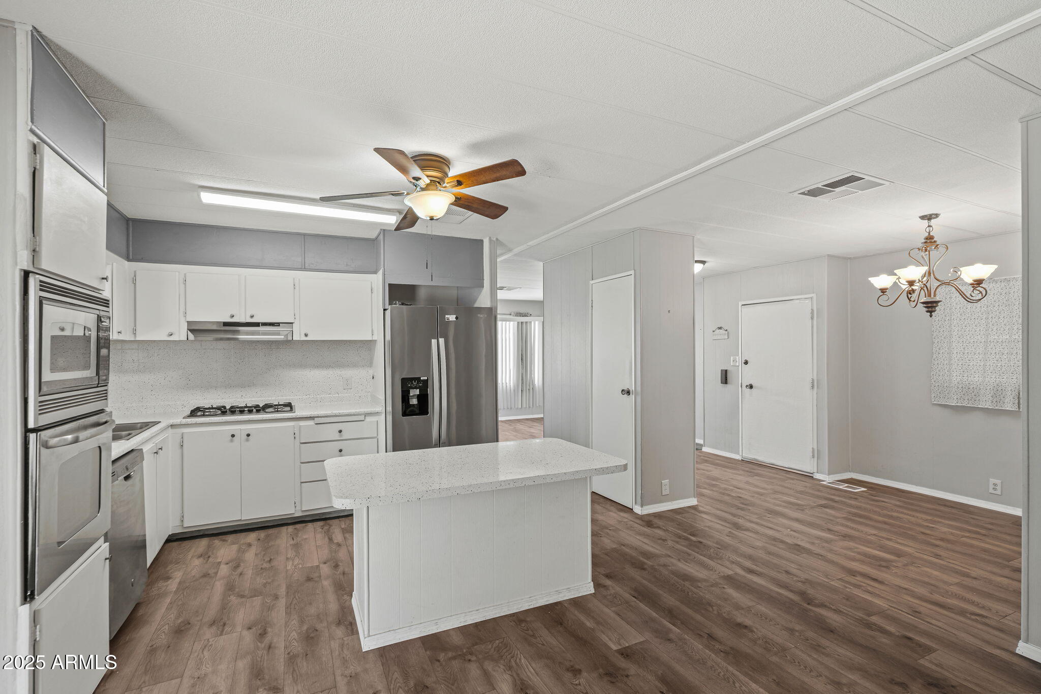 201 South Greenfield Road, Unit 207 Mesa, AZ 85206 - Photo 12 of 50 a large kitchen with cabinets and wooden floor