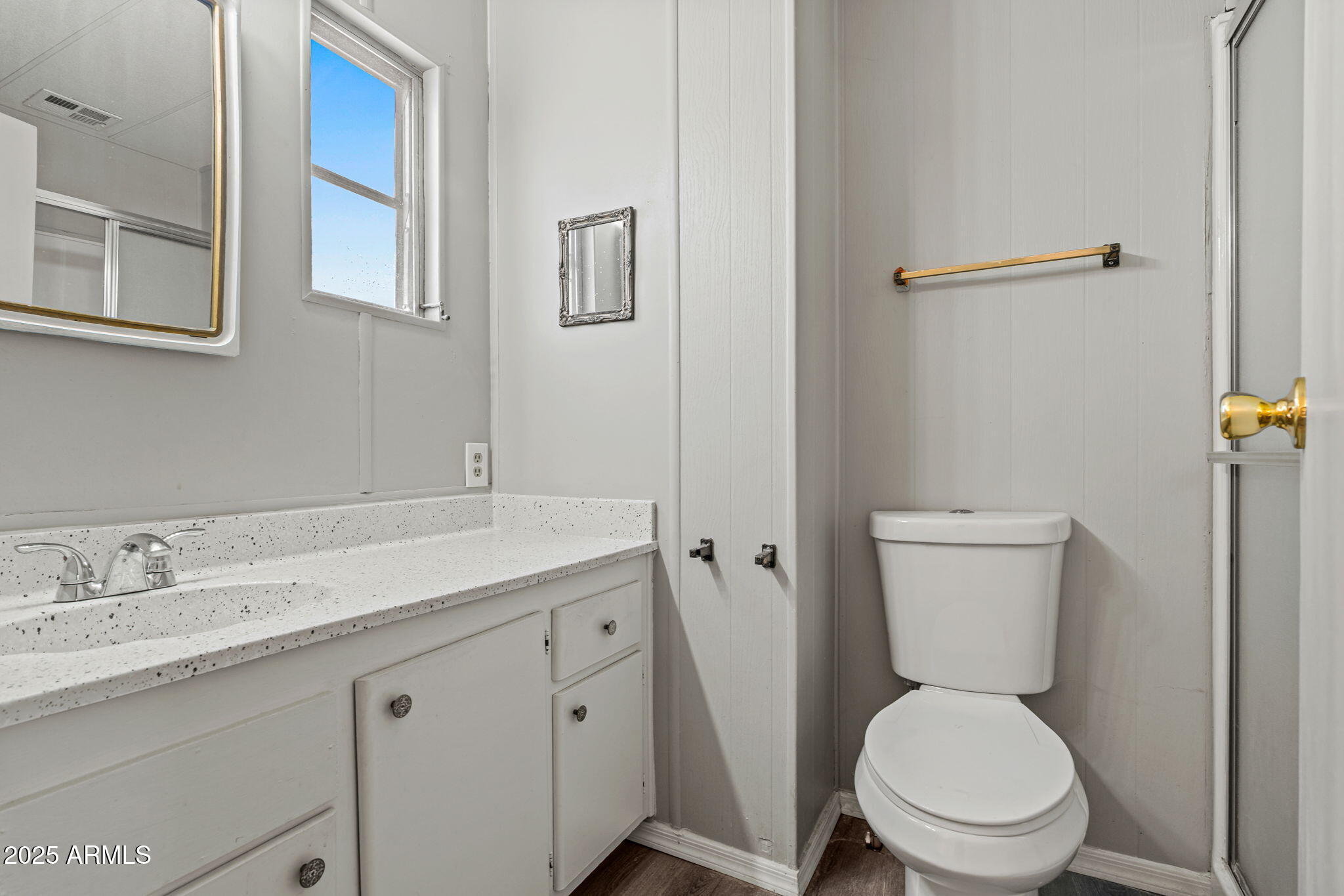 201 South Greenfield Road, Unit 207 Mesa, AZ 85206 - Photo 21 of 50 a bathroom with a toilet a sink and mirror
