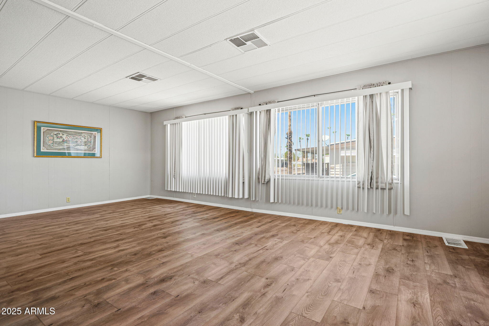 201 South Greenfield Road, Unit 207 Mesa, AZ 85206 - Photo 34 of 50 an empty room with wooden floor and windows