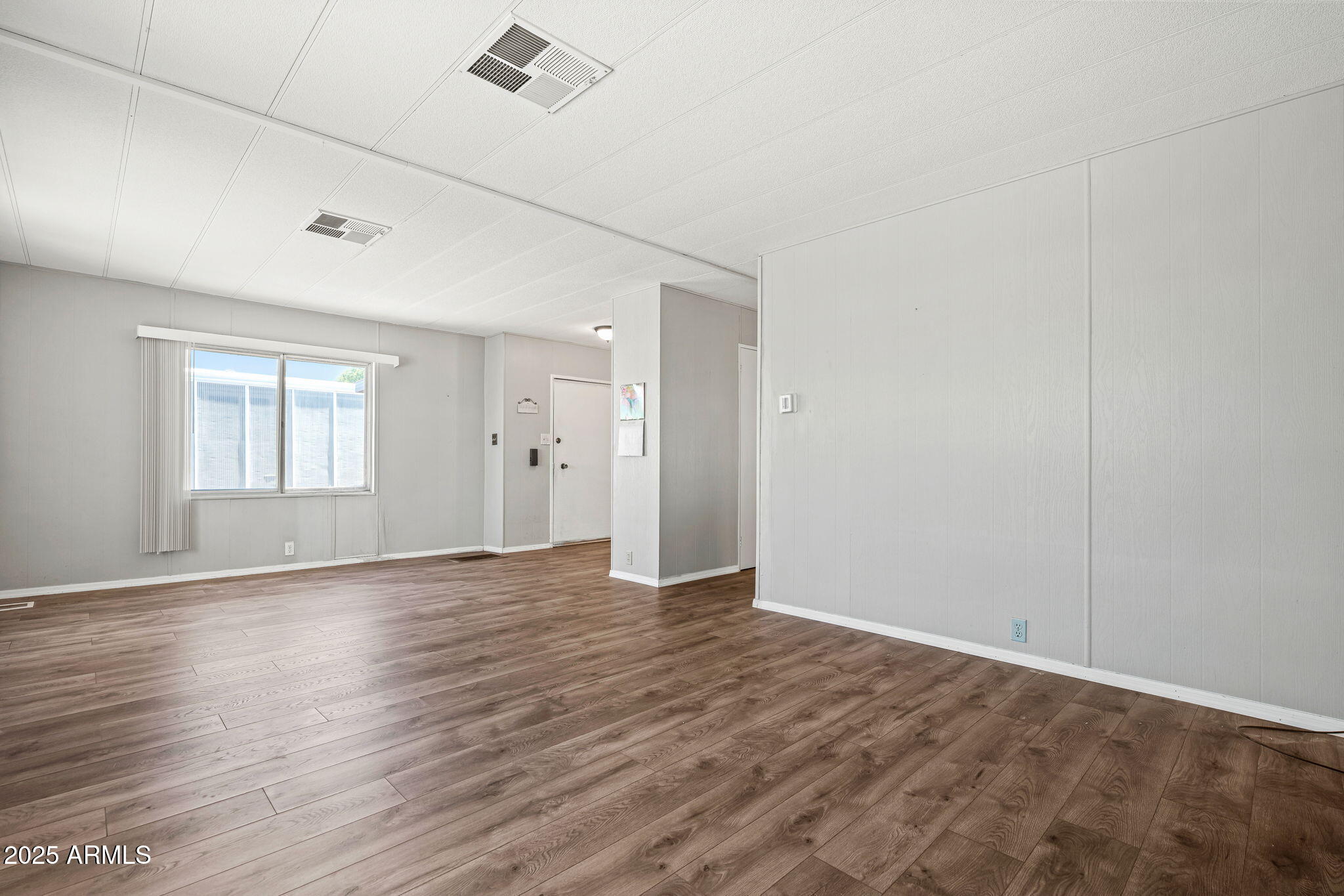 201 South Greenfield Road, Unit 207 Mesa, AZ 85206 - Photo 37 of 50 an empty room with wooden floor and windows