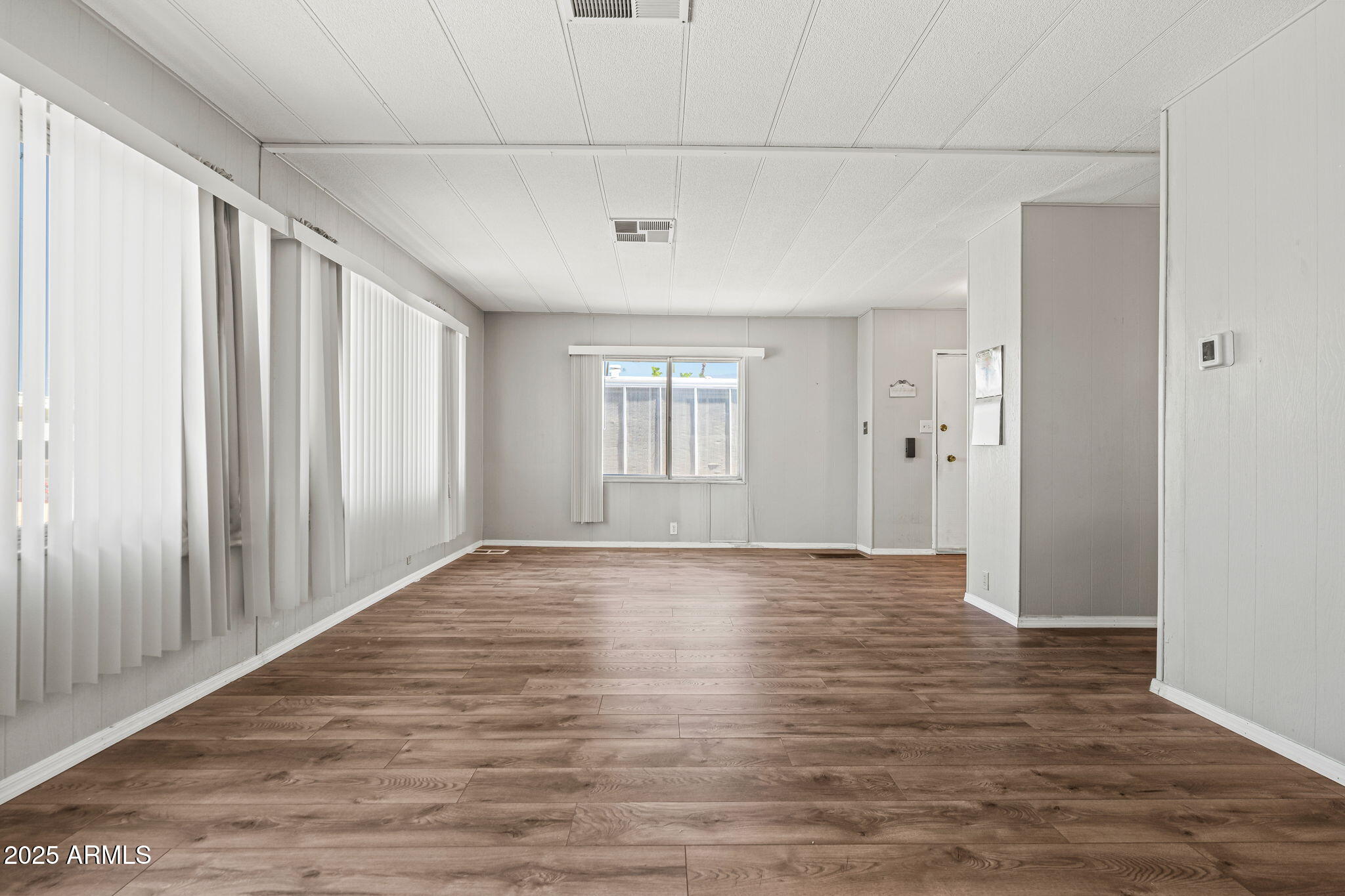 201 South Greenfield Road, Unit 207 Mesa, AZ 85206 - Photo 38 of 50 a view of an empty room with window and wooden floor