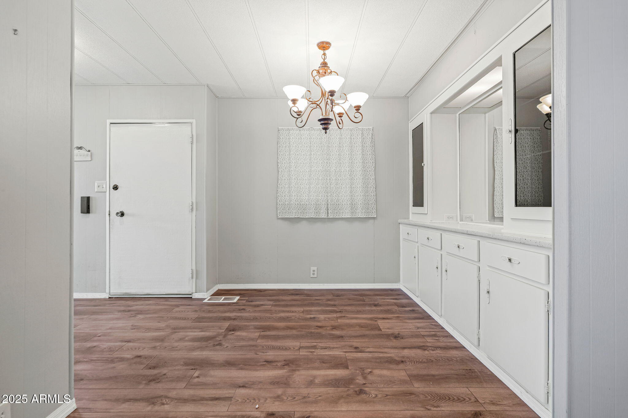 201 South Greenfield Road, Unit 207 Mesa, AZ 85206 - Photo 42 of 50 a view of a chandelier fan and wooden floor