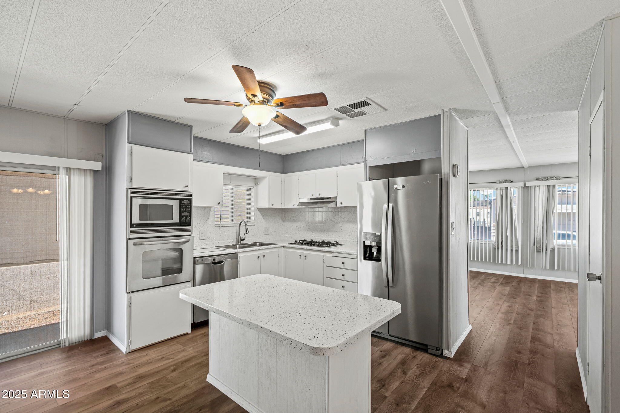 201 South Greenfield Road, Unit 207 Mesa, AZ 85206 - Photo 49 of 50 a kitchen with stainless steel appliances a refrigerator and a stove top oven