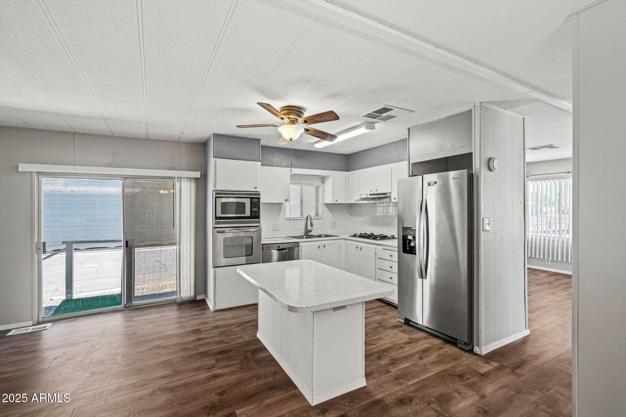 201 South Greenfield Road, Unit 207 Mesa, AZ 85206 - Photo 50 of 50 a kitchen with stainless steel appliances a refrigerator and a stove top oven