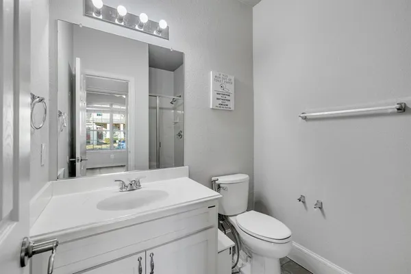 a kitchen with stainless steel appliances granite countertop a refrigerator a sink dishwasher a stove and white countertops with wooden floor