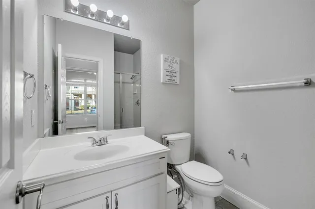 a kitchen with stainless steel appliances granite countertop a refrigerator a sink dishwasher a stove and white countertops with wooden floor