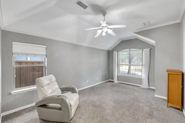 a living room with furniture and a ceiling fan