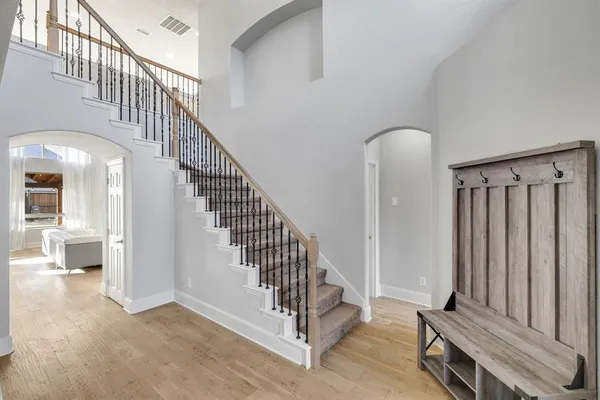 a view of staircase with white walls and a window