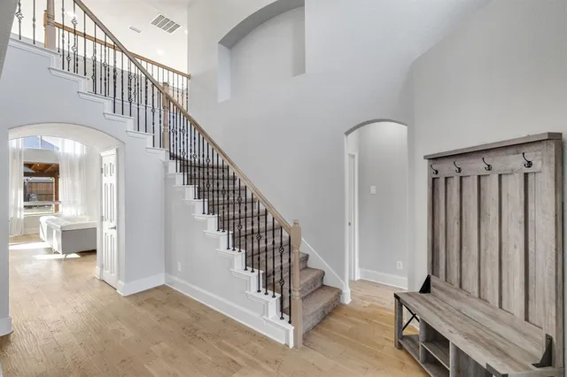 a view of staircase with white walls and a window