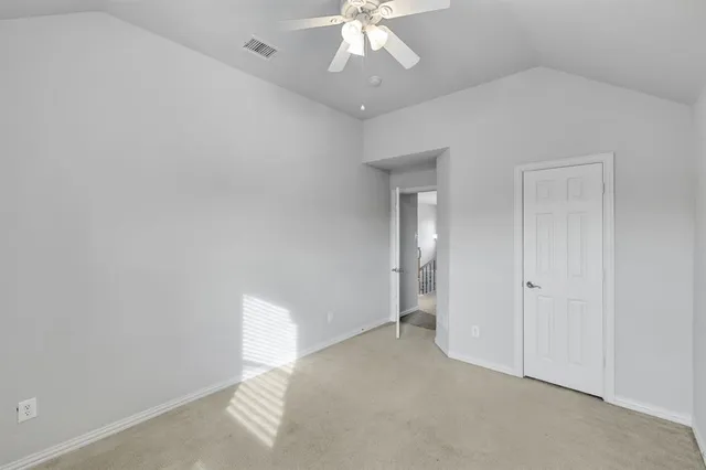 an open kitchen with white cabinets and chandelier