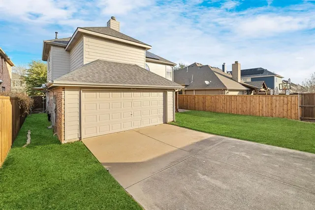 a view of a yard with wooden fence and a bench