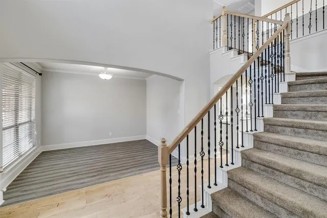 a view of staircase with wooden floor and a window