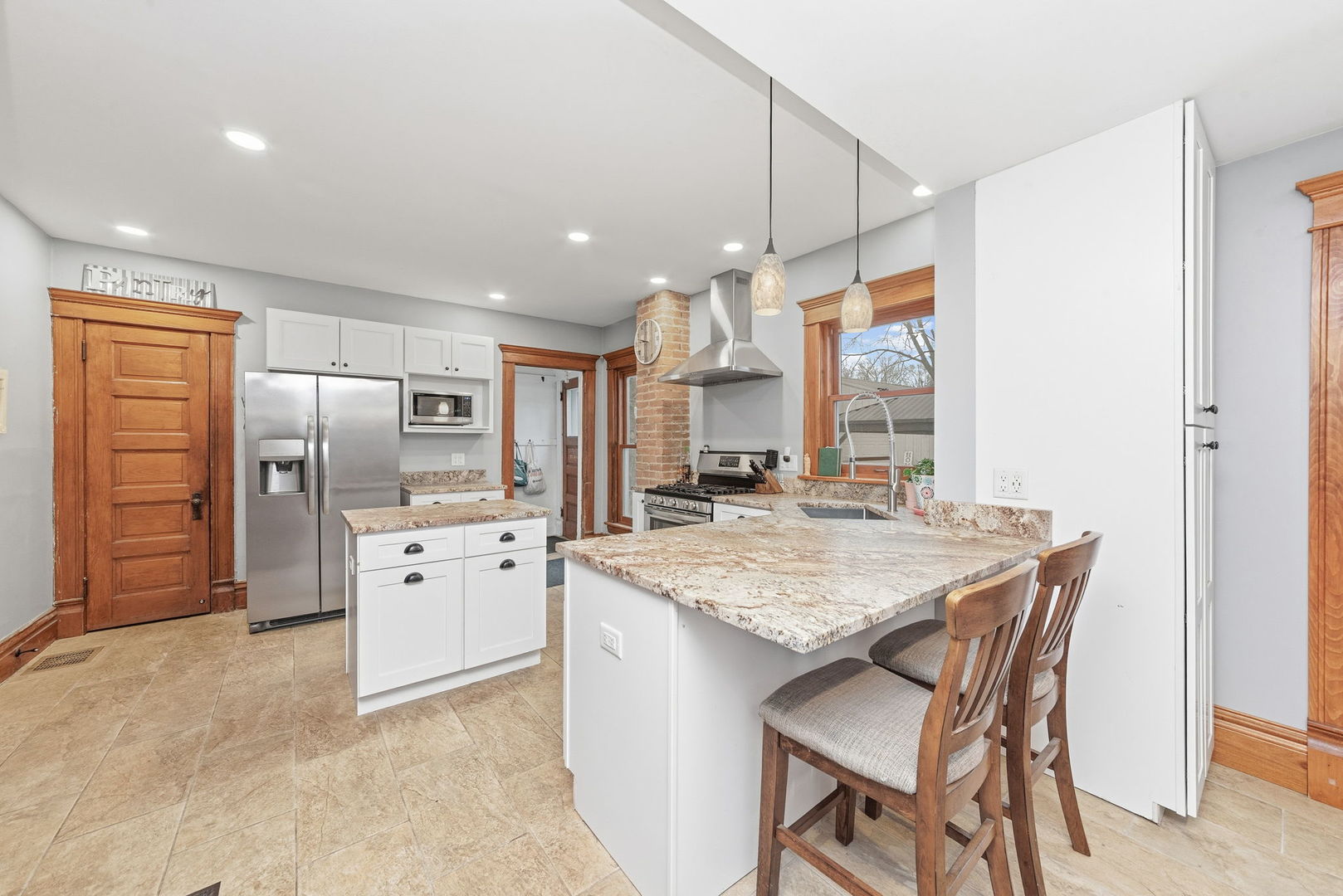 410 West Reader Street Elburn, IL 60119 - Photo 5 of 19 a kitchen with stainless steel appliances granite countertop a kitchen island a stove a refrigerator a sink a dining table and chairs