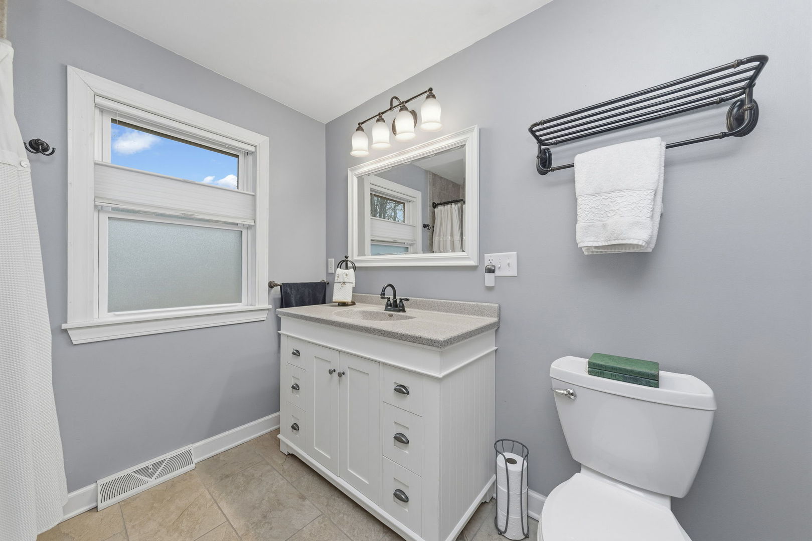 410 West Reader Street Elburn, IL 60119 - Photo 8 of 19 a bathroom with a toilet sink and mirror