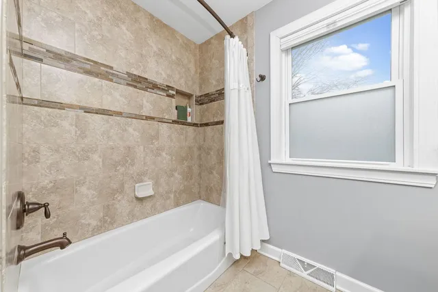 a bathroom with a bathtub and a shower