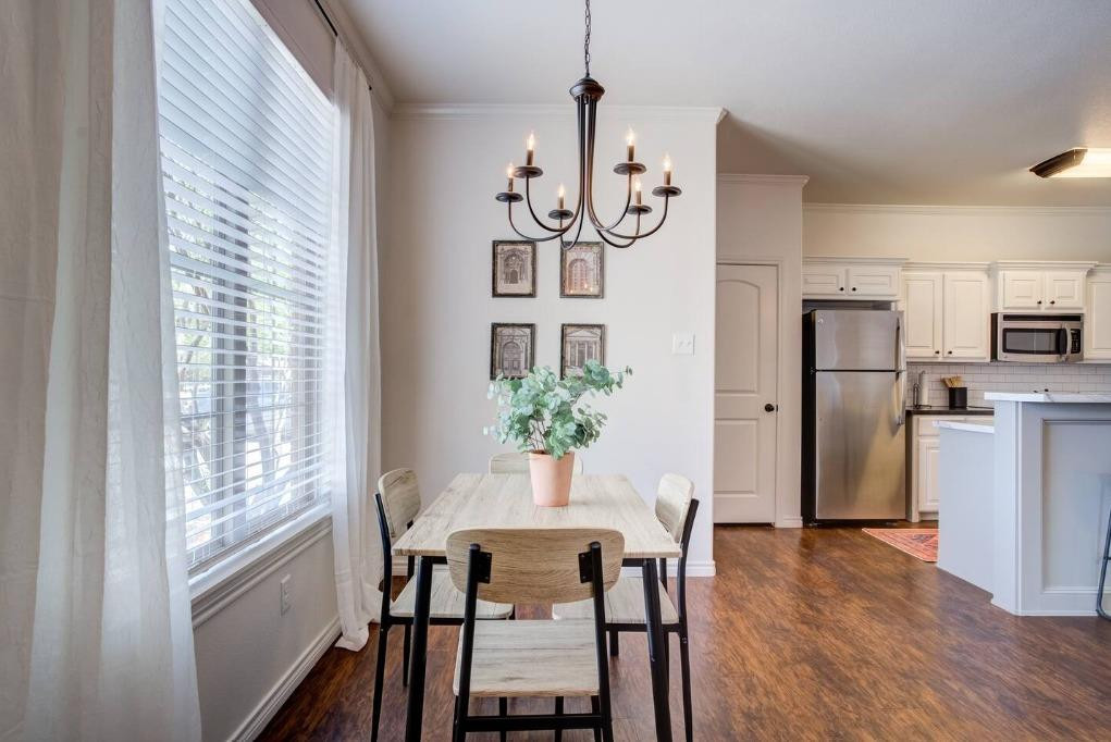 3107 33rd Street, Unit 1 Lubbock, TX 79410 - Photo 16 of 22 a view of a dining room with furniture window and wooden floor