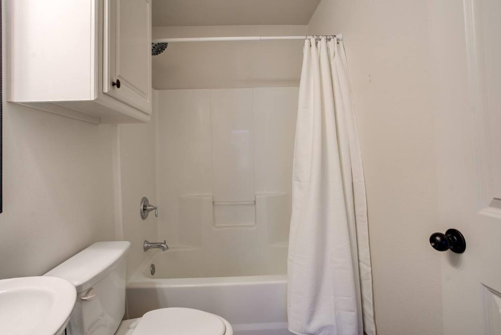 3107 33rd Street, Unit 1 Lubbock, TX 79410 - Photo 19 of 22 a bathroom with a shower and a toilet