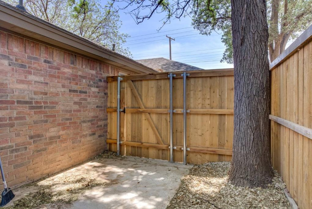 3107 33rd Street, Unit 1 Lubbock, TX 79410 - Photo 22 of 22 a view of a backyard with a tree