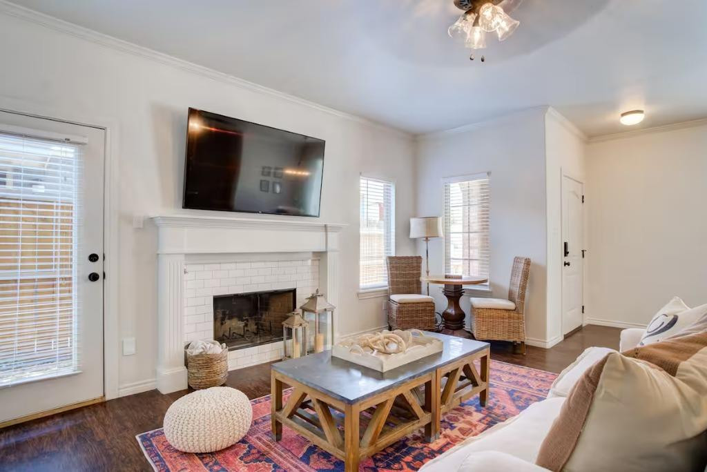 3107 33rd Street, Unit 1 Lubbock, TX 79410 - Photo 3 of 22 a living room with furniture a fireplace and a flat screen tv