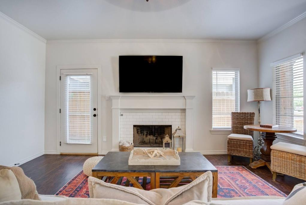 3107 33rd Street, Unit 1 Lubbock, TX 79410 - Photo 5 of 22 a living room with furniture and a fireplace