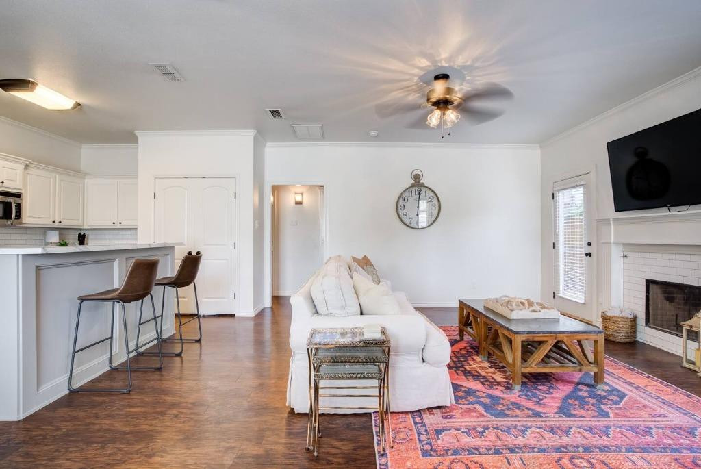 3107 33rd Street, Unit 1 Lubbock, TX 79410 - Photo 6 of 22 a living room with furniture fireplace and flat screen tv