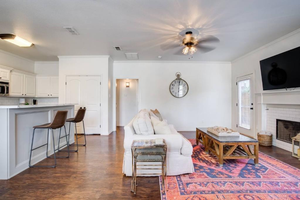 3107 33rd Street, Unit 1 Lubbock, TX 79410 - Photo 7 of 22 a living room with furniture fireplace and flat screen tv