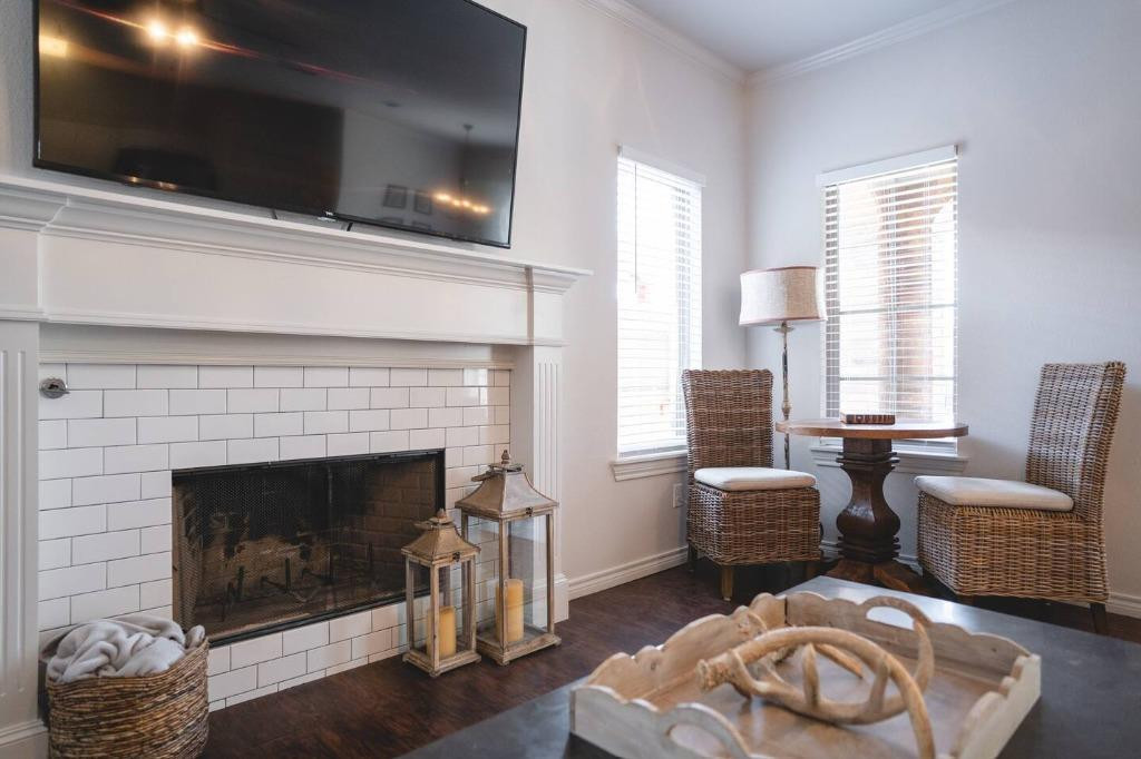 3107 33rd Street, Unit 1 Lubbock, TX 79410 - Photo 10 of 22 a living room with furniture and a flat screen tv